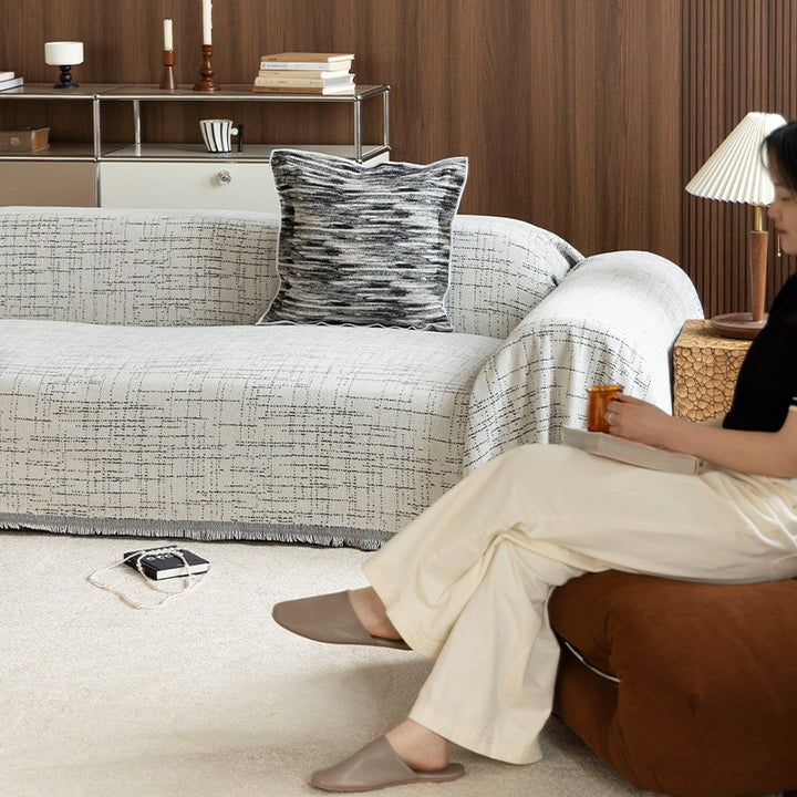 Universal sofa throw made of woven cotton blend with fringes and gentle upholstery cover