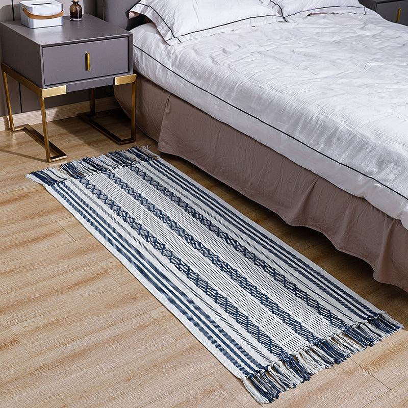 Flat-woven cotton runner with fringes and graphic ethnic stripe pattern