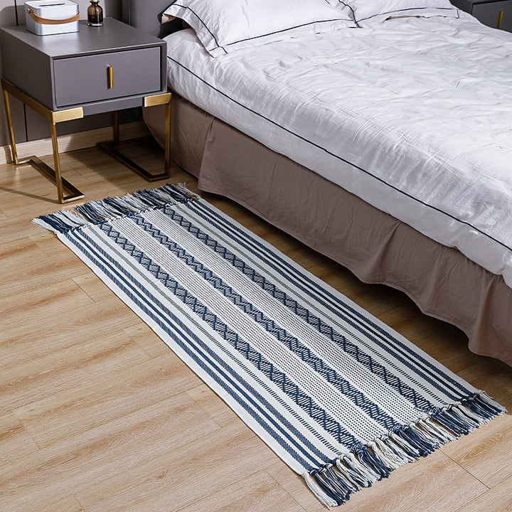 Flat-woven cotton runner with fringes and graphic ethnic stripe pattern