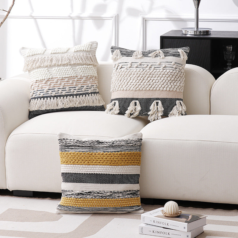 High-structured woven decorative cushion cover with fringes and bouclé application