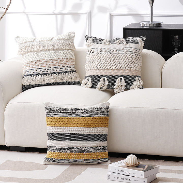 High-structured woven decorative cushion cover with fringes and bouclé application