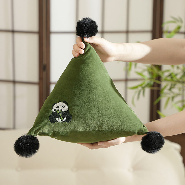 Pyramid-shaped triangle cushion with faux fur pom-poms and zebra embroidery