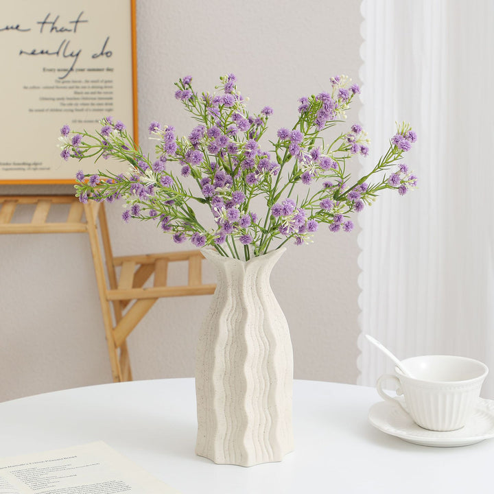 Decorative artificial flower branch with delicate purple flowers