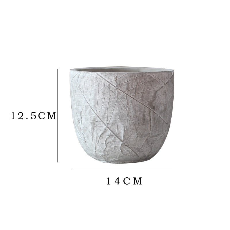 Decorative plant container made of handmade ceramic with leaf pattern