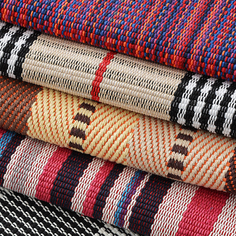 Woven living area rug with large check pattern and flat cotton texture