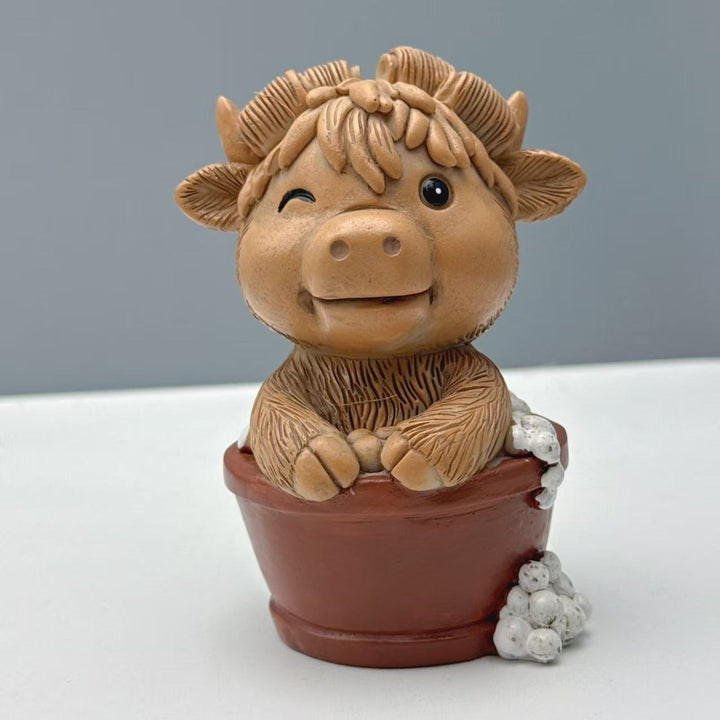 Funny decorative figure of a Highland cow on toilet