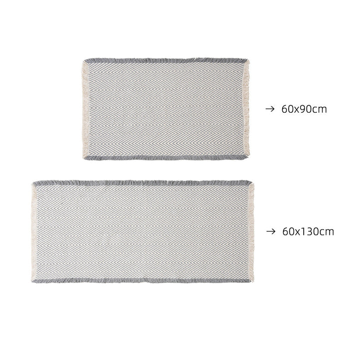 Handwoven cotton bath mat with herringbone pattern and fringes