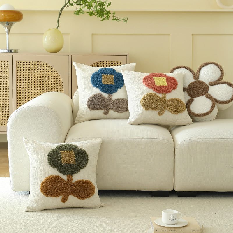 Decorative tufted cushion cover with hand-tufted flower applique