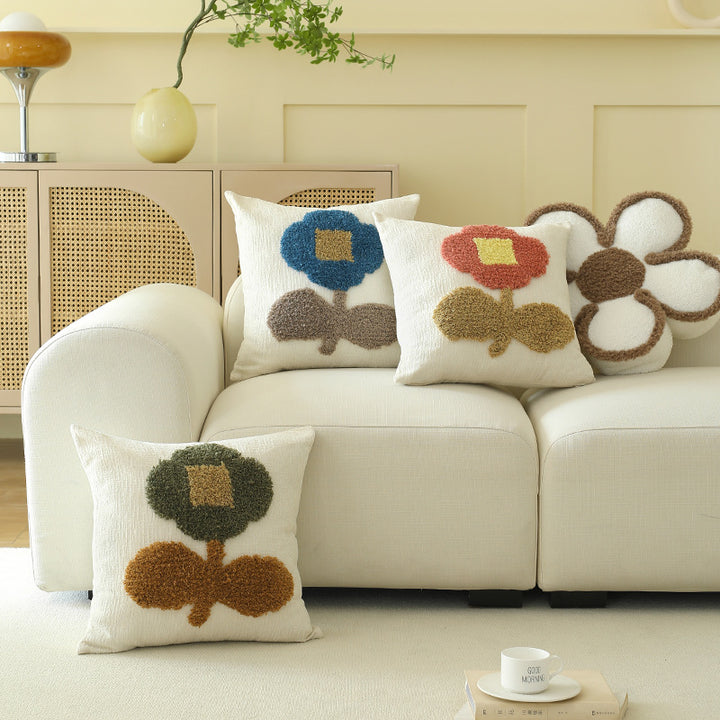 Decorative tufted cushion cover with hand-tufted flower applique