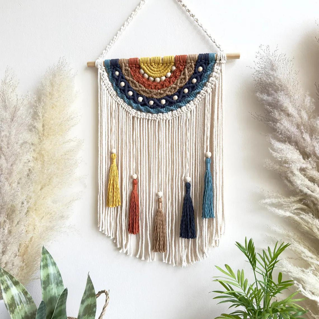 Artistic macrame wall hanging with colorful tassels and decorative elements
