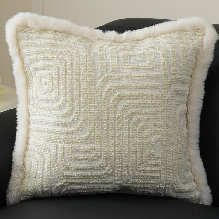 Square decorative pillow with embossed circular relief and soft faux fur edging