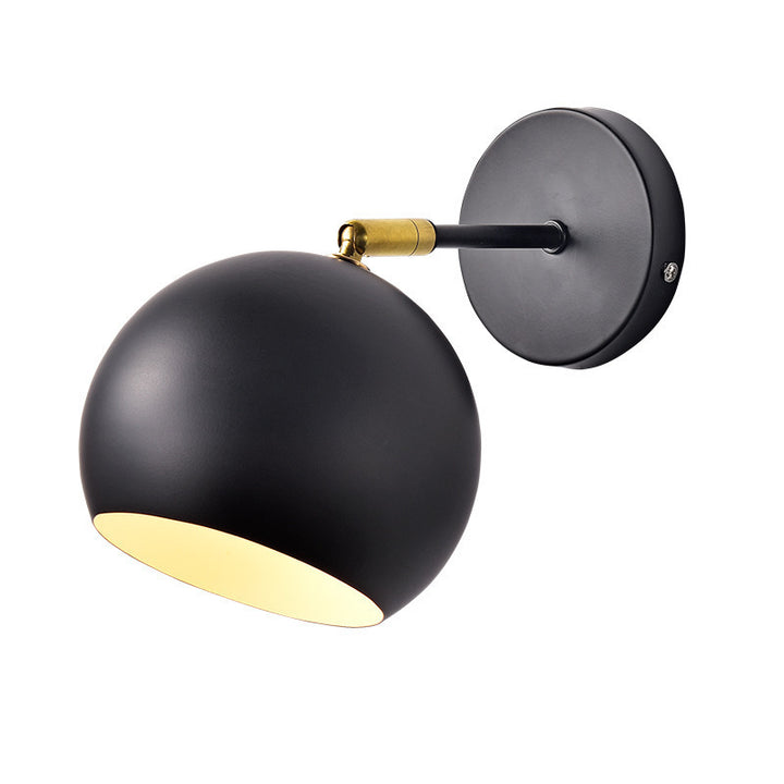 Adjustable matte metal globe wall lamp with brass pivot arm