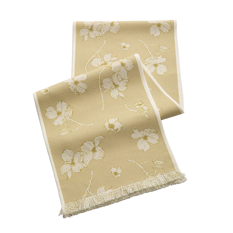 Woven table runner with floral jacquard pattern and fringed edge