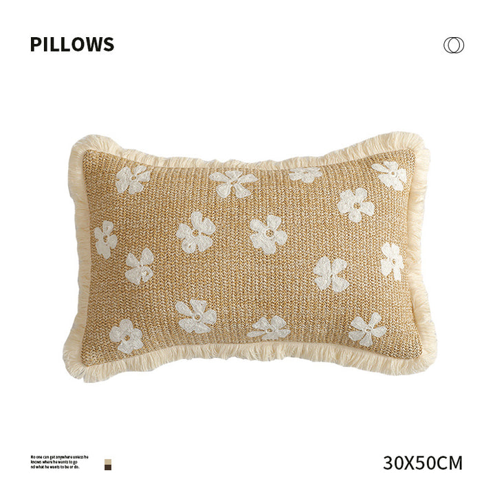 Rectangular woven decorative pillow with contrasting flower tufting and fringe trim