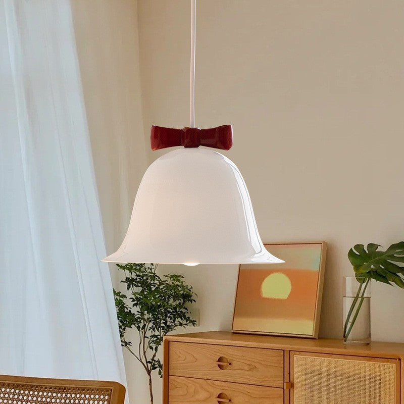 Bell-shaped ceramic pendant light with decorative bow accent