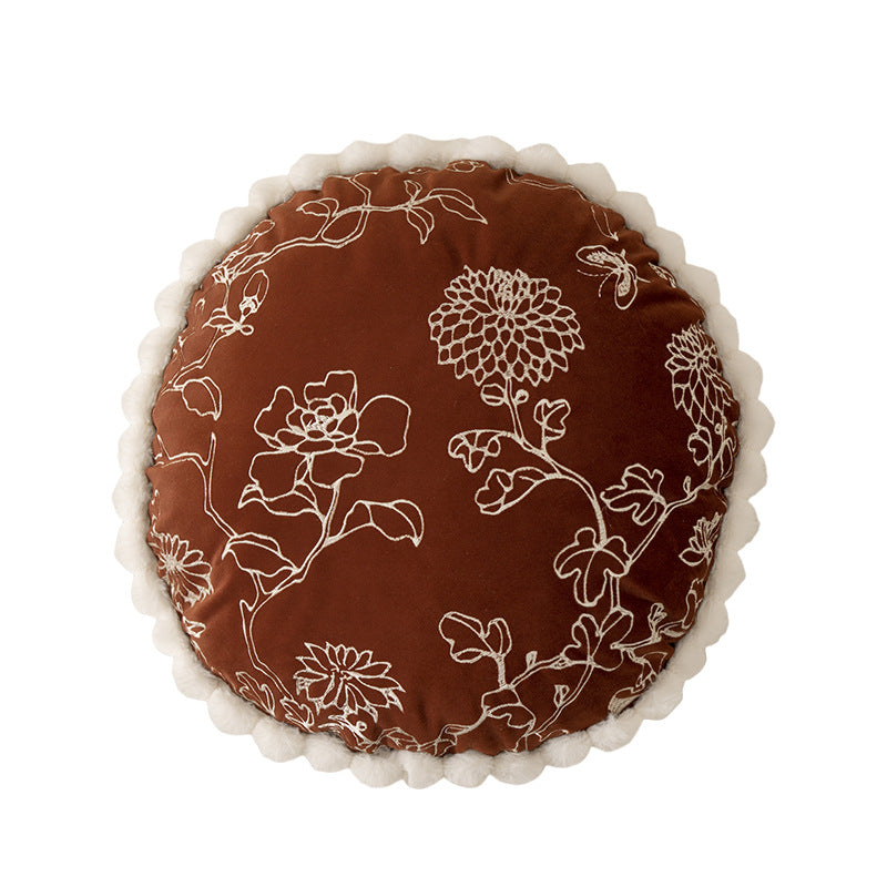 Round decorative cushion with floral embroidery relief look and wavy satin border