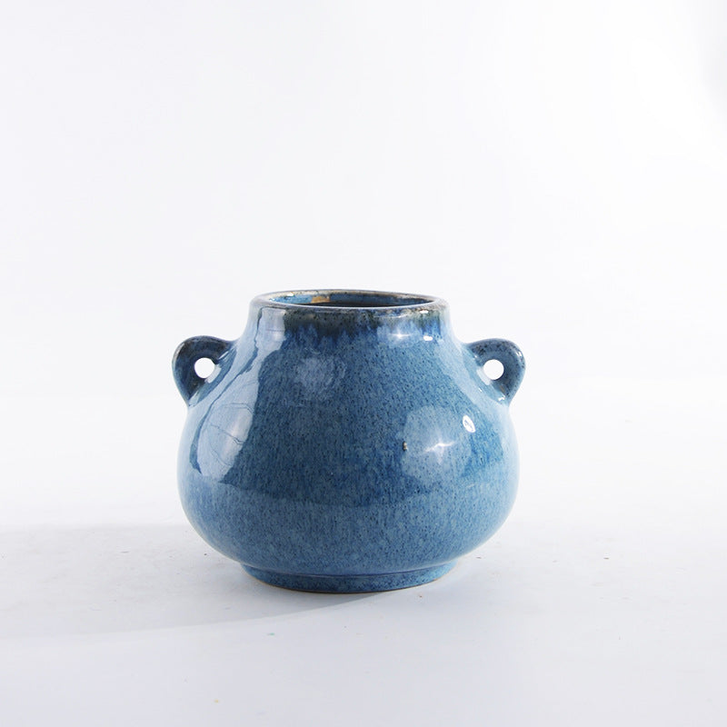Decorative ceramic pot with playful handles