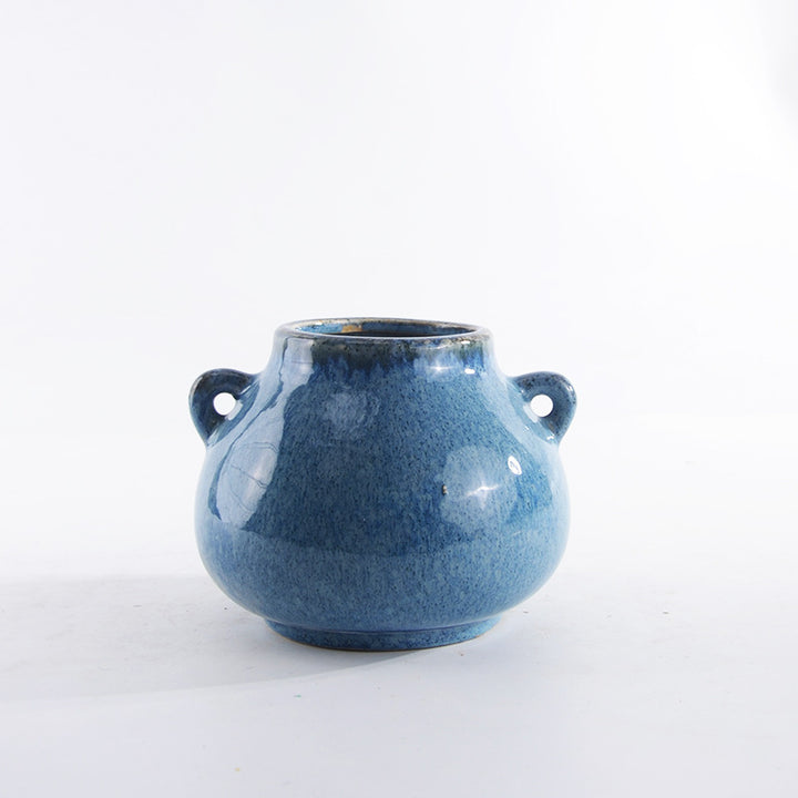 Decorative ceramic pot with playful handles