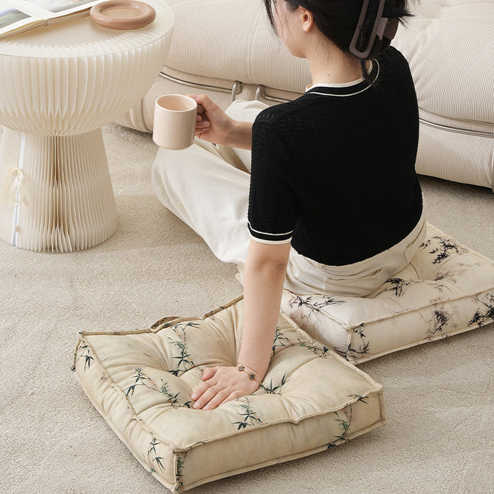 Padded square seat cushion with tufted stitching and fine bamboo print