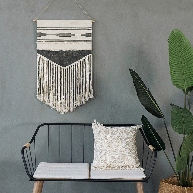 Handwoven wall hanging made of cotton blend with layered textures, wood rod and long fringes