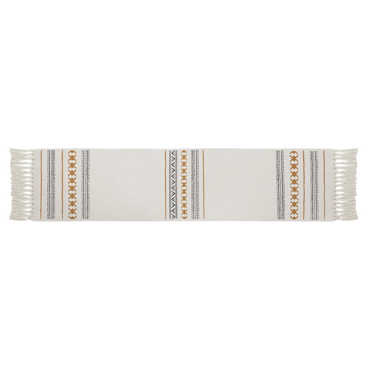 Woven Boho table runner made of cotton blend with decorative fringes and graphic stripe pattern