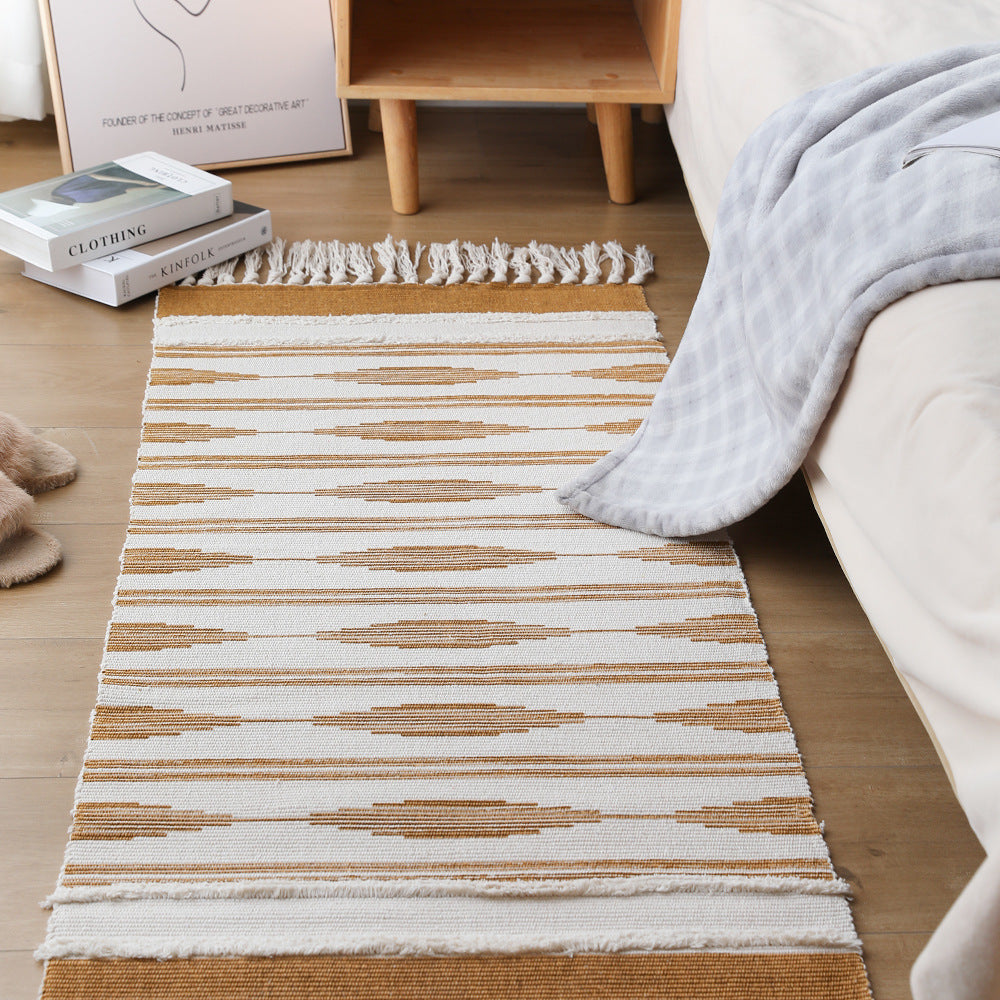 Flat Boho runner rug made of cotton blend fabric with geometric hexagon tufting and decorative fringed edge.