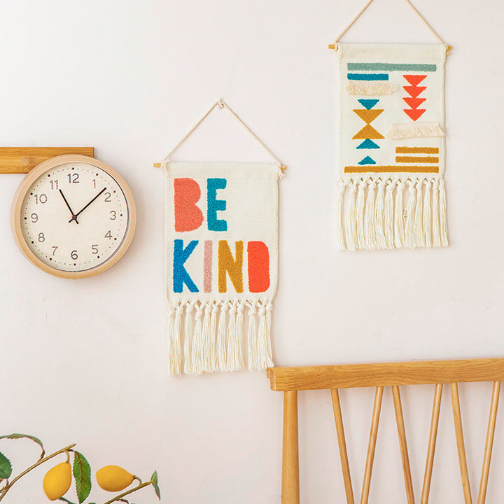 Boho wall hanging made of woven cotton with hand-tufted appliqués and fringes