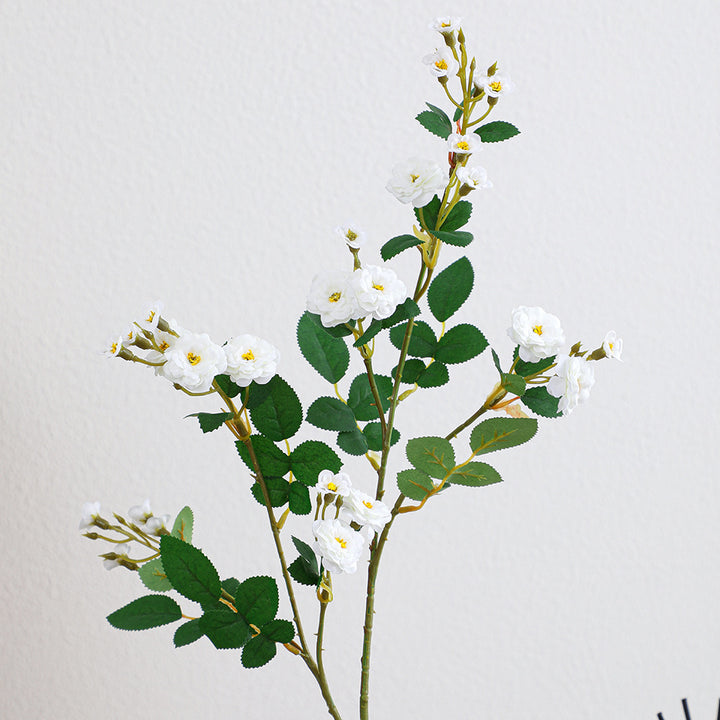 Artificial branch with decorative flowers