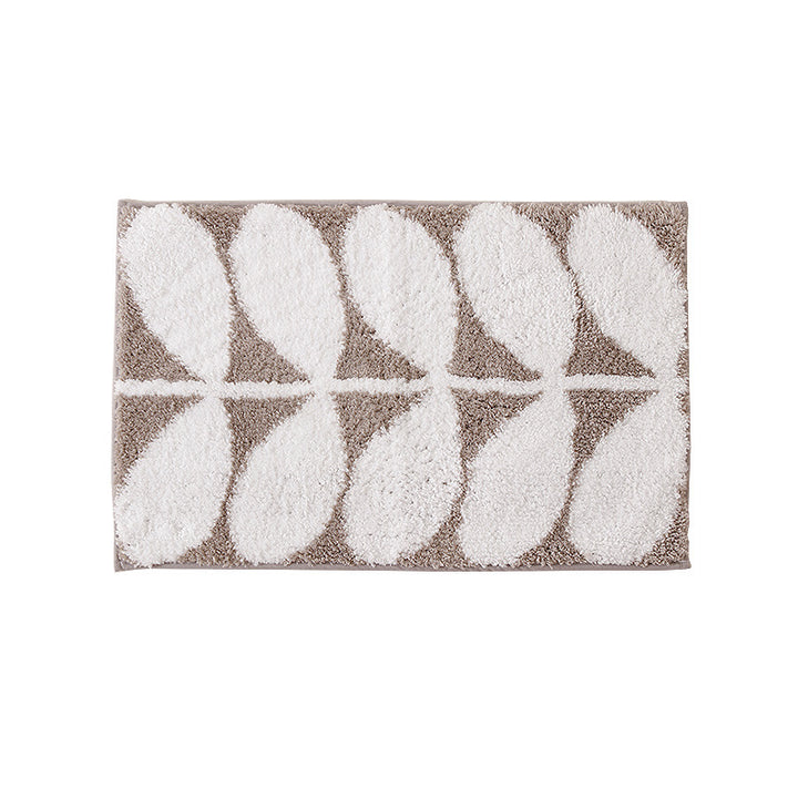 Fluffy bath mat in a graphic wave relief with anti-slip base