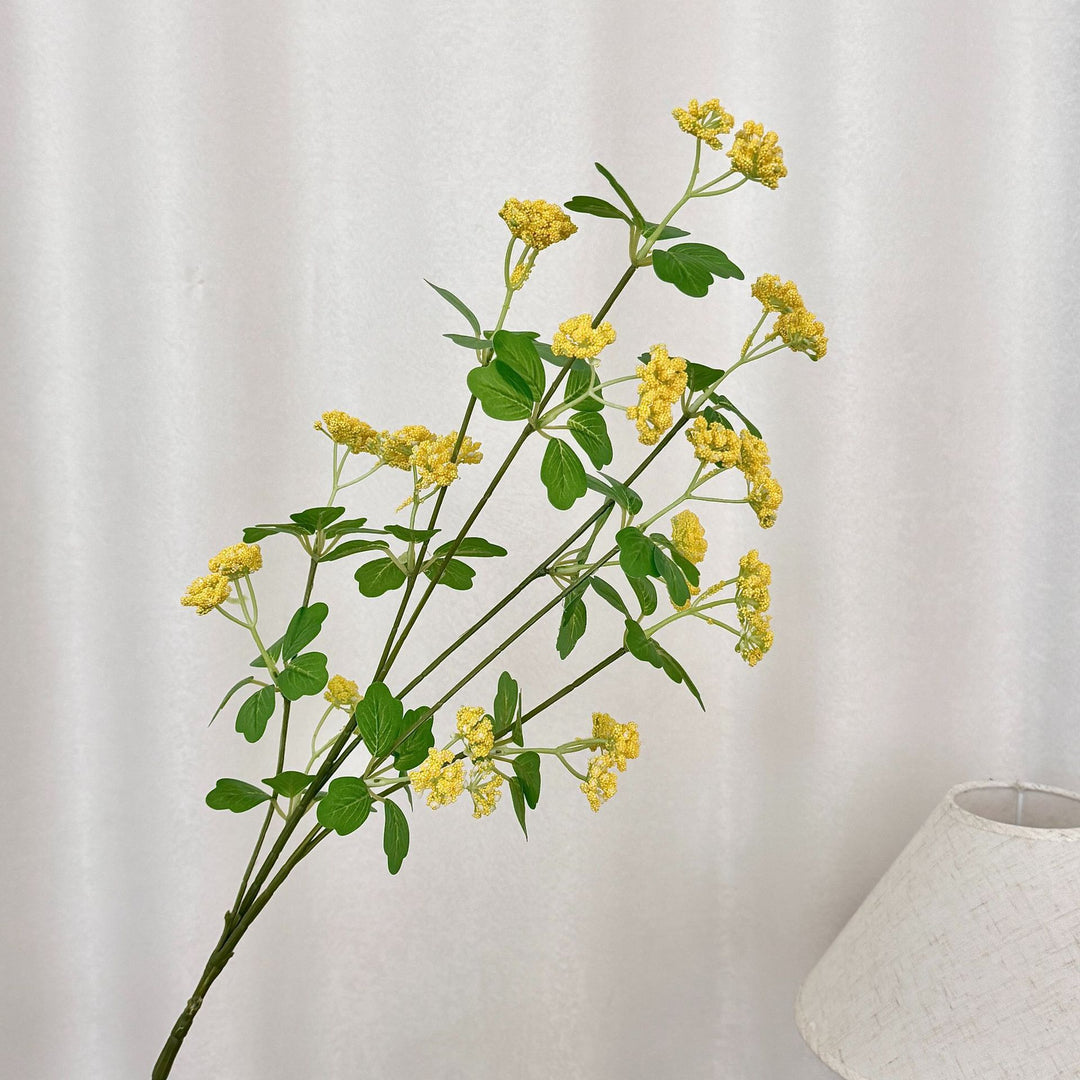 Artificial blossom branch with purple flowers