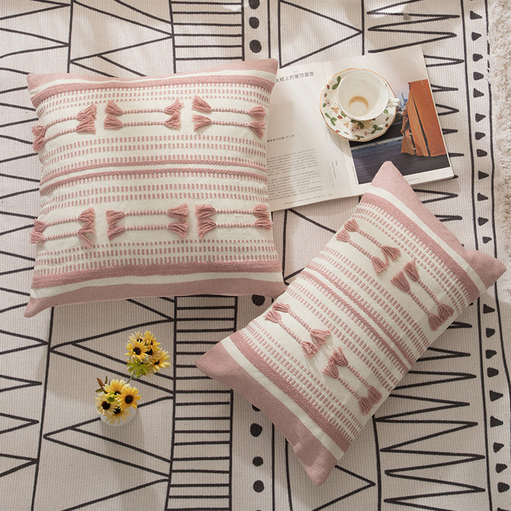 Woven decorative cushion cover with ordered tassel application and structured jacquard weaving