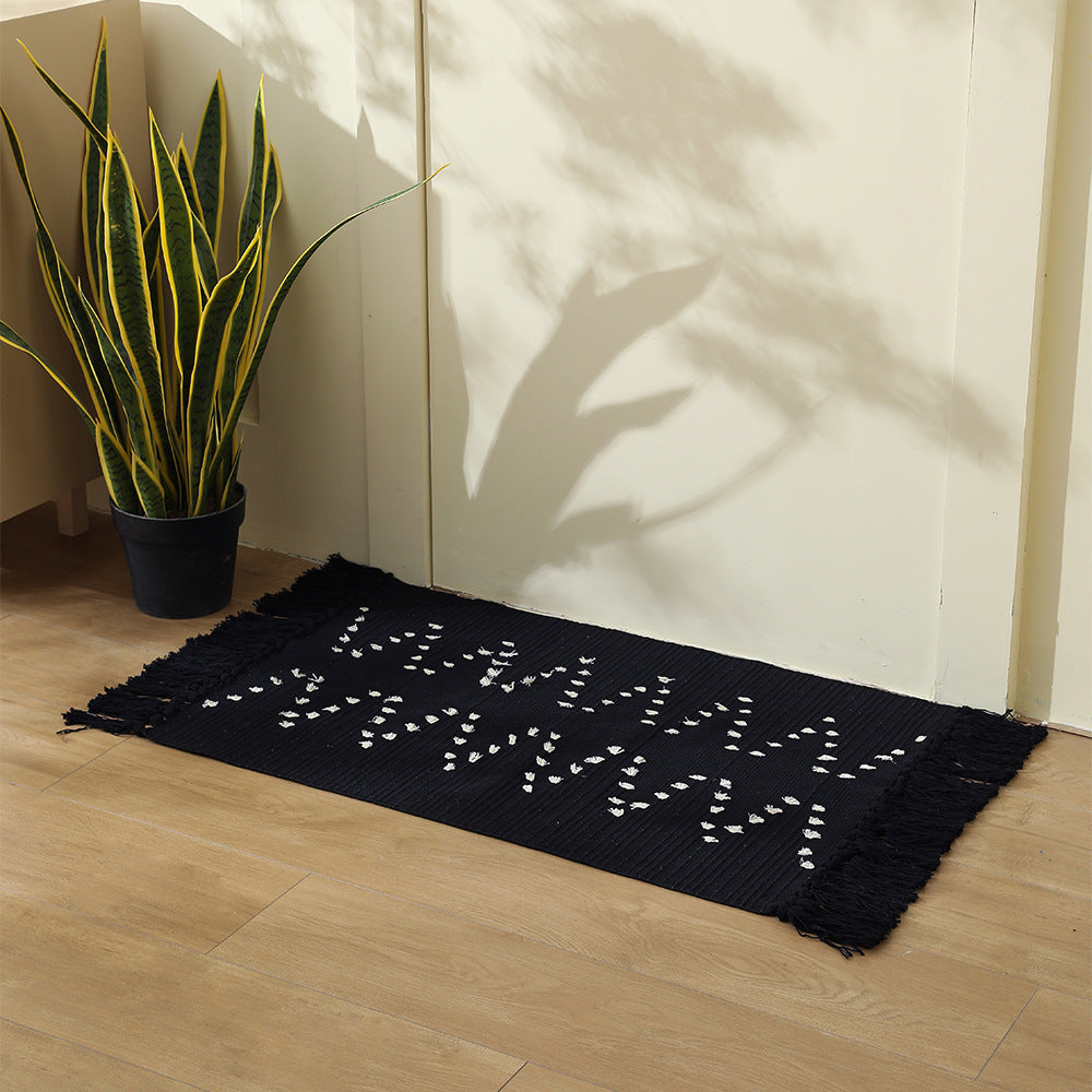 handwoven living room rug with fringes and geometric perforated pattern