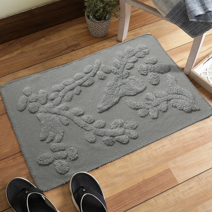 Rectangular cotton bath mat with abstract 3D tuft relief and non-slip back