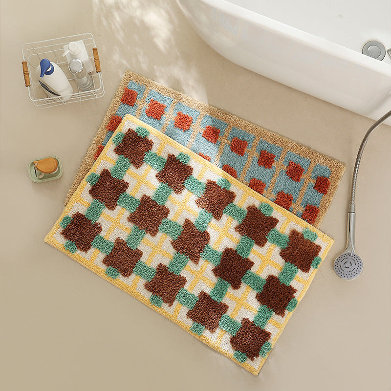 Hand-tufted bathroom bath mat with non-slip backing and textured square relief