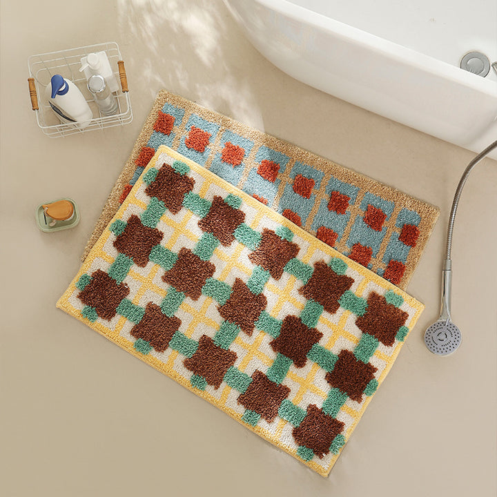 Hand-tufted bathroom bath mat with non-slip backing and textured square relief