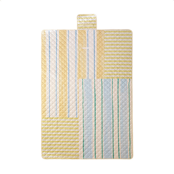 Padded outdoor picnic blanket with quilting, carrying flap and lightweight water-repellent cover