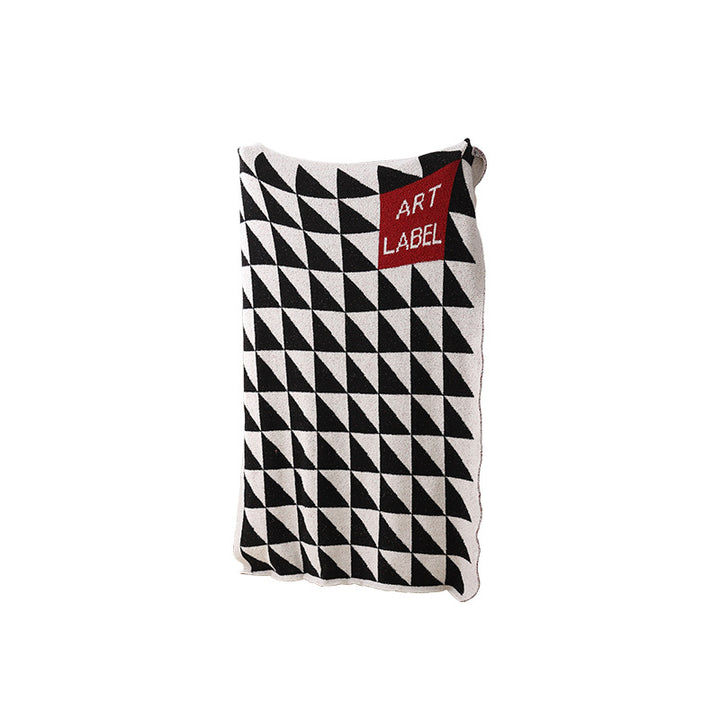 Coarsely woven decorative blanket with geometric jacquard pattern and soft bouclé