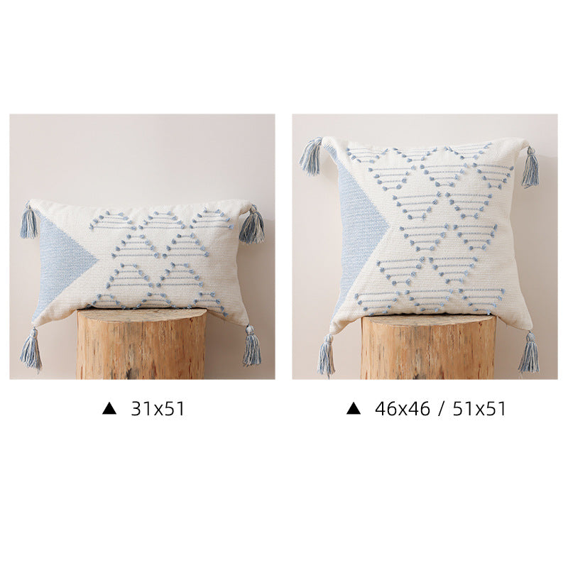 Decorative woven cushion cover with geometric tuft-relief and tassels