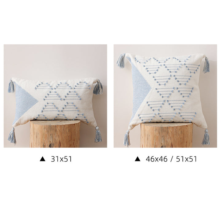 Decorative woven cushion cover with geometric tuft-relief and tassels