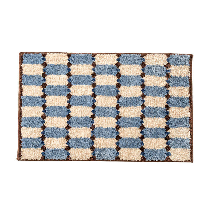 Hand-tufted bathroom mat with a velvety pile, non-slip latex backing, and geometric honeycomb check pattern