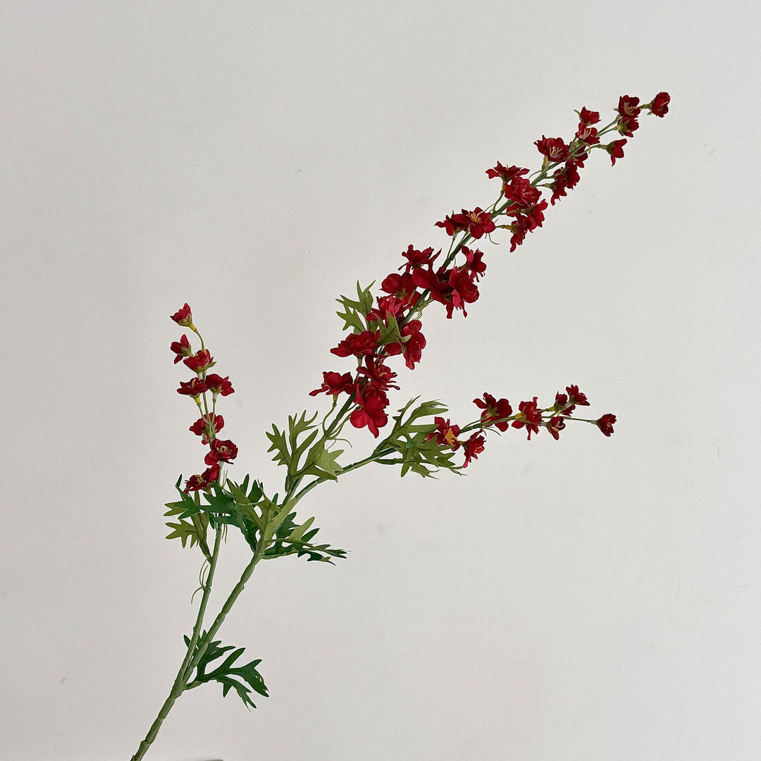 Artificial flower branch with intricately detailed red flowers