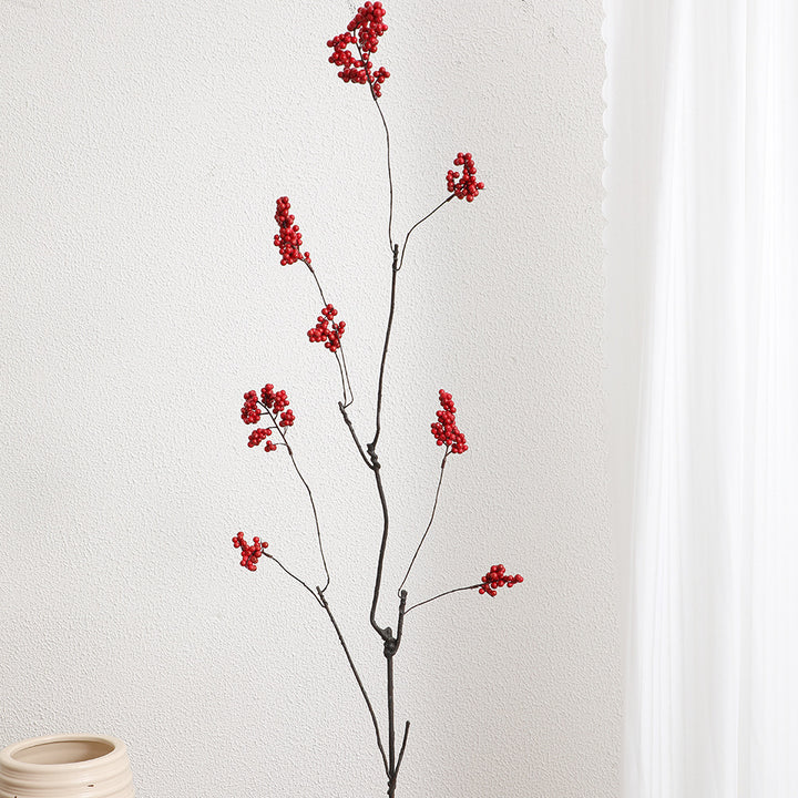 Decorative artificial flower branch with glowing red berries