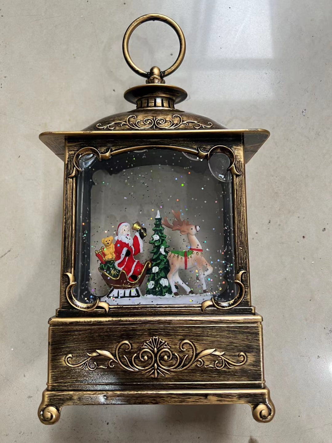 Glittering Christmas lantern with snow scenes