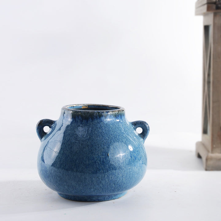 Decorative ceramic pot with playful handles