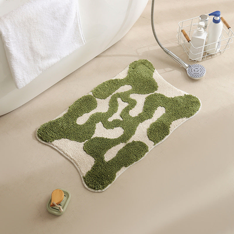 Hand-tufted bathroom bath mat with non-slip backing and textured square relief