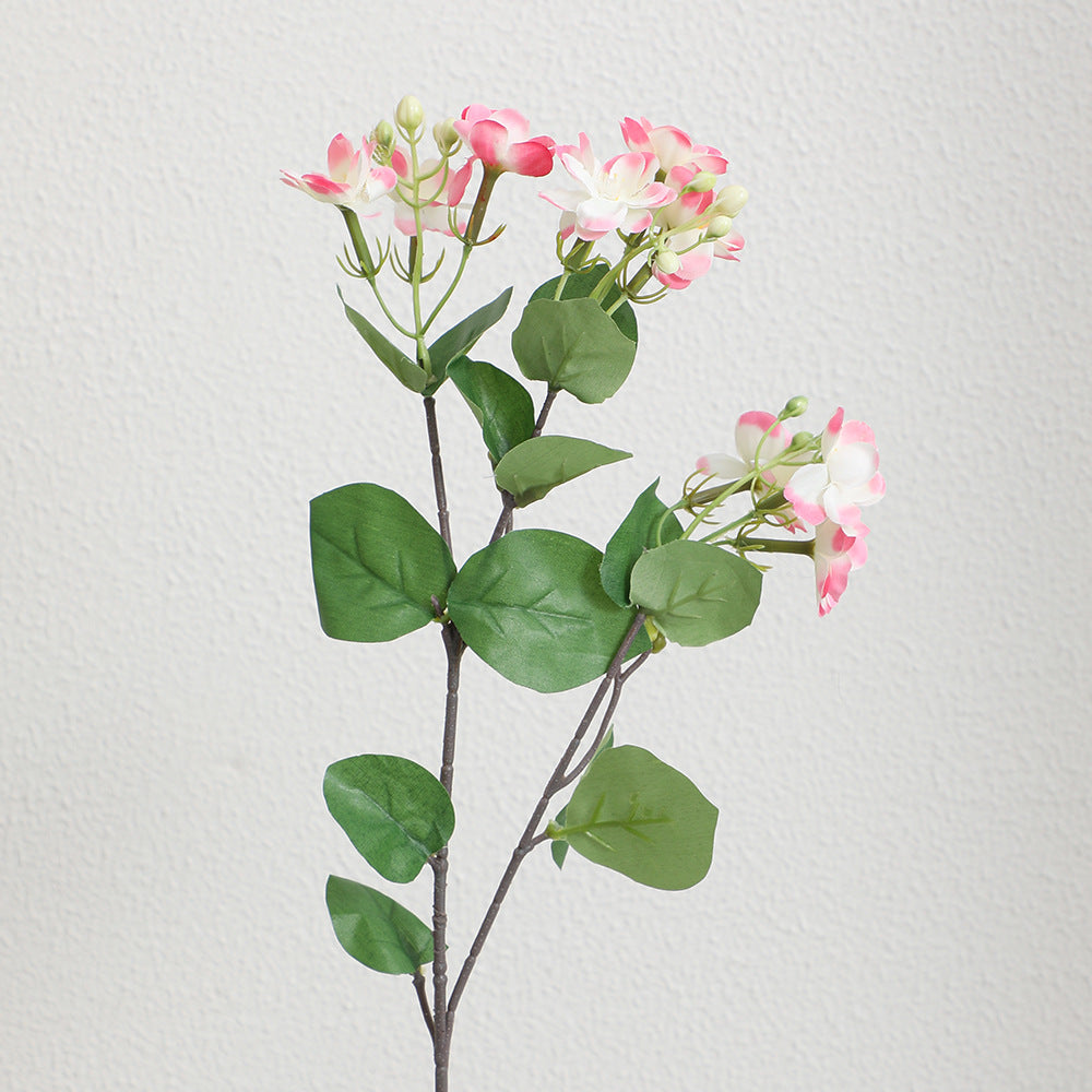 Artificial flower branch with vibrant pink flowers