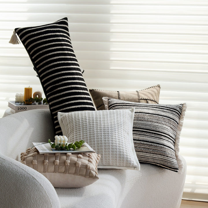 Woven home decor pillow cover with fine striped texture and hand-fringed edge