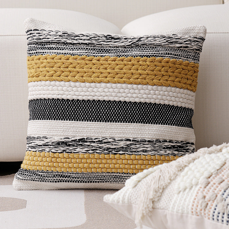High-structured woven decorative cushion cover with fringes and bouclé application