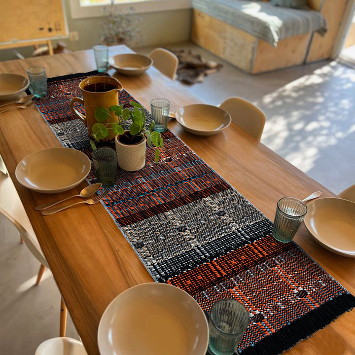 Woven table runner in ethnic look made of cotton blend with fringes