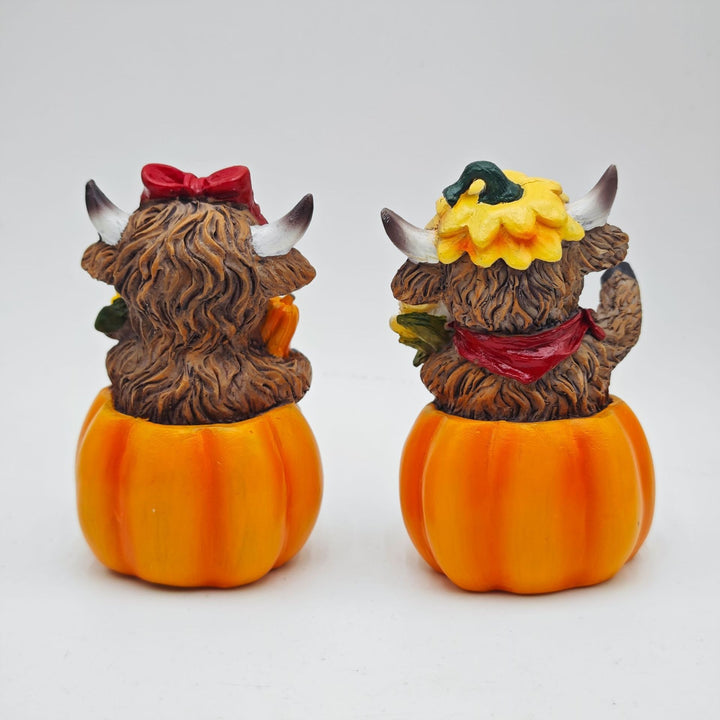 Funny decorative figure of a Highland cow in pumpkin costume